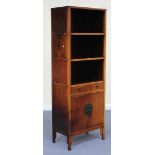A late 20th Century South-east Asian softwood upright display cabinet, fitted with an arrangement of