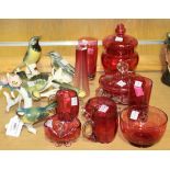 Three Karl Ens porcelain bird groups and a small collection of cranberry glassware.