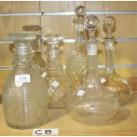 A group of six decanters and stoppers, including three triple ring neck decanters with cut