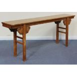 A 20th Century Chinese elm altar table, the rectangular top with scroll supports, on moulded legs,