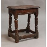 A 17th Century oak joint stool, the moulded rectangular seat raised on turned and block legs