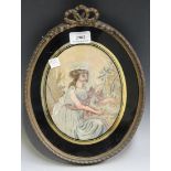 A 19th Century oval silkwork of a young girl holding a lamb, seated within a woodland setting,