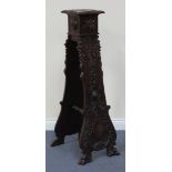 A late 19th Century Continental walnut jardinière stand carved with masks, leaves and a cartouche,