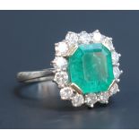 An 18ct white gold, emerald and diamond ring, claw set with a square emerald with canted corners