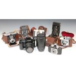 A collection of assorted cameras, lenses and accessories, including a Yashica-44 camera, a Canon EOS