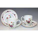 A pair of Worcester porcelain coffee cups and saucers, circa 1770, each painted and gilt with sprays