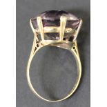 A 9ct gold ring, claw set with a circular cut amethyst, ring size approx S.