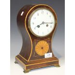 An Edwardian mahogany mantel clock with eight day movement striking on a gong, the enamel dial