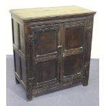 A late 17th/early 18th Century oak side cupboard, fitted with a pair of fielded panel doors, on