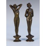 A near pair of Art Nouveau brown patinated cast bronze figural desk seals, each in the form of a