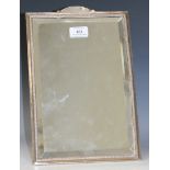 A George V silver framed dressing table mirror of rectangular form with arch surmount and