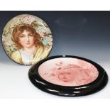 An Aesthetic Staffordshire pottery circular charger, late 19th Century, painted with a head and