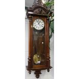 A late 19th Century walnut cased Vienna style wall clock with eight day movement striking on a gong,
