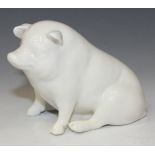 A Belleek model of a white glazed pig, brown printed factory mark to base, height approx 7.5cm.