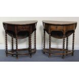 A near pair of George V oak demi-lune drop-flap side tables, each fitted with a single frieze drawer