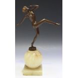 An Art Deco brown and gilt patinated cast spelter full-length figure of a nude dancing girl, in