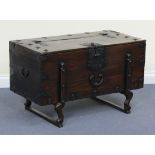 A 20th Century Chinese elm and wrought metal bound grain chest with shaped supports, height approx