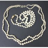 A single row necklace of graduated cultured pearls on a gold and cultured pearl clasp, and a two row