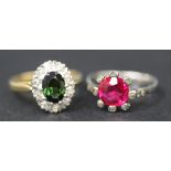 An 18ct gold ring, claw set with an oval cut green tourmaline within a surround of circular cut