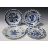 Four delftware plates, mid-18th Century, each painted in blue with a floral or chinoiserie design,