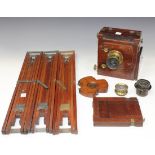 A late 19th Century mahogany and lacquered brass mounted folding plate camera with black leather