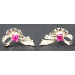 A pair of diamond and ruby ear studs of abstract ribbon bow form, each mounted with a square cut