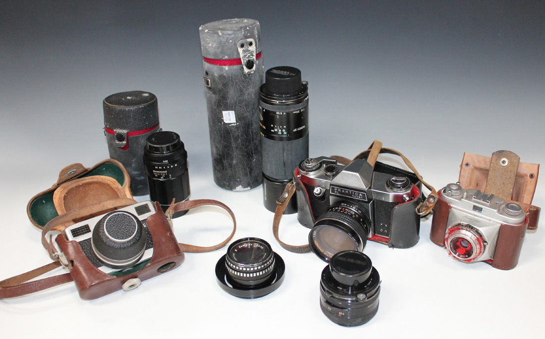 A small group of cameras and lenses, including a Praktica PL Noval camera with auto Chinon 1:2.8 F=