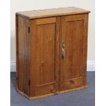 An early 20th Century stripped pine wall cabinet, fitted with a pair of panel doors revealing a