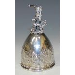 A Continental .925 silver hand bell with a figural finial accompanied by a dog, above an ovoid