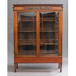 An Edwardian satinwood and mahogany display cabinet, the frieze with crossbanded decoration and