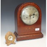An early 20th Century mahogany cased mantel clock with eight day movement striking on a gong, the