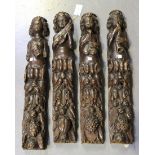 A set of four 19th Century carved oak herm pilasters, each modelled with a curly-haired figure