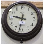 An early 20th Century Bakelite cased circular wall clock with eight day movement, the white dial