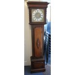 A George V oak longcase clock with eight day movement chiming on gongs, the square brass dial with