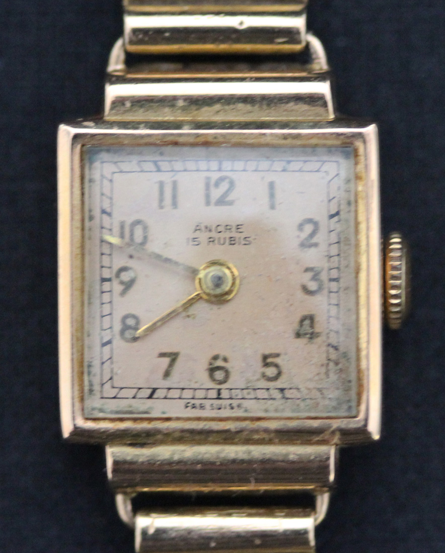 An Ancre gold rectangular cased lady's wristwatch, the signed square gilt dial with gilt Arabic