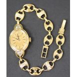 A Rolex 18ct gold and diamond set lady's dress wristwatch, the signed oval gilt dial with black