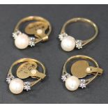 Four 9ct gold rings, each mounted with a single cultured pearl at the centre, between a small