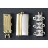 A platinum and gold rectangular three row necklace clasp, width approx 1cm, a gold three row