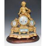 A late 19th Century French gilt spelter and porcelain mounted mantel clock with eight day movement