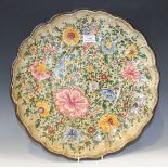 An Italian pottery circular dish painted with flowers within a lobed rim, painted 'C.A. Rossi,