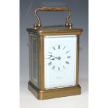 An early 20th Century French lacquered brass cased carriage timepiece, the white enamel dial with