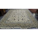 A Central Persian carpet, mid-20th Century, the ivory field with overall scrolling vines ending in