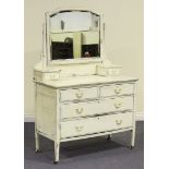 A late Victorian white painted dressing chest, fitted with a swing mirror and an arrangement of