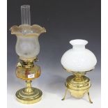 A Victorian brass oil table lamp with glass reservoir and shade, impressed 'Hinks & Sons Patent',