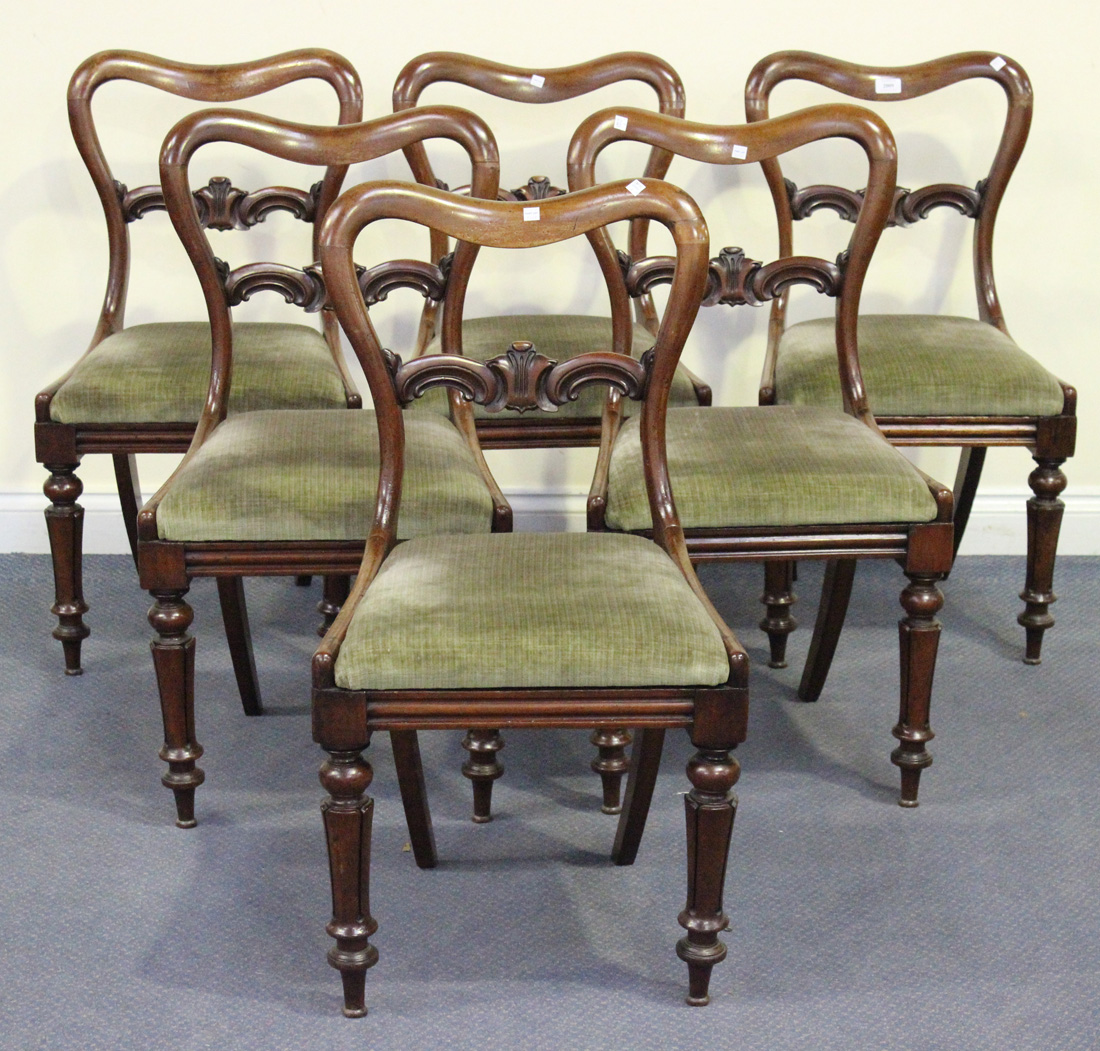 A set of six mid-Victorian mahogany bar and spoon back dining chairs, the upholstered drop-in