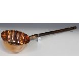 An early 19th Century copper brewer's ladle, the bowl inscribed 'W. Sanders 1823', with a turned