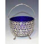 A Victorian silver sugar basket of circular form with overhead swing handle, above pierced scroll