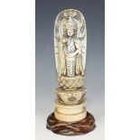 A Japanese carved and stained ivory figure of Lakshmi, Meiji/Taisho period, the goddess modelled