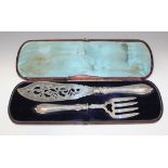 A pair of Victorian silver fish servers, with pierced and engraved scroll decoration, Birmingham