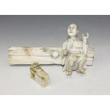 A Japanese carved ivory okimono figure, Meiji period, modelled as a crouching gentleman resting